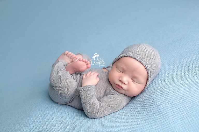 Newborn in romper with hoodie